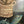 Still life painting with bread in a basket and fish on a table.
