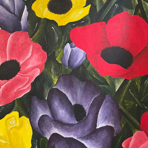 Framed painting of colorful flowers on a wall