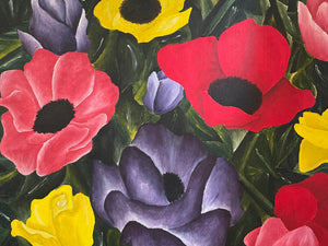 Framed painting of colorful flowers on a wall