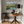 Room interior with a wooden table, chair, lamp, and painting of a mountain landscape.