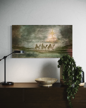 Framed artwork of a religious scene with figures and a cross on a wall above a wooden console table.