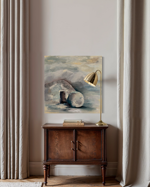 Decorative interior scene with a painting, lamp, and wooden cabinet against a light wall.