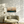 Modern living room with a textured sofa, floor lamp, and wall art.
